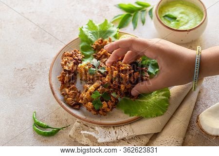Indian Cuisine Indian Food. Pakora With Coconut Chutney Sauce Curry Leaves. Hand Of Young Indian Wom