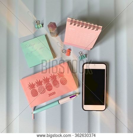 Flat Layout Of Blank Notepad With Pen And Stickers On Green Background