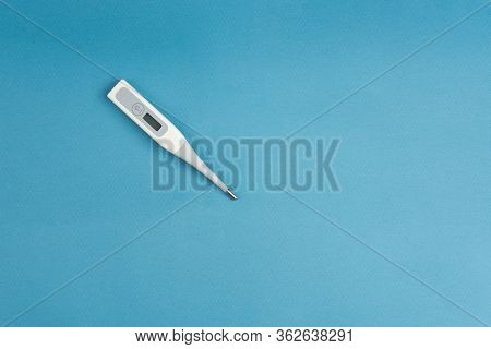 Electronic Thermometer With A Flexible Tip On A Blue Background