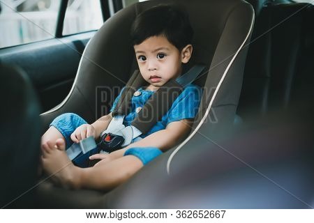 Adorable Baby Boy In Safety Car Seat. Portrait Happy Toddler Boy Sitting In The Car Seat. Boy Sittin