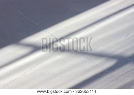 Abstract Shadow Background In The Form Of Horizontal And Vertical Lines On A White Wooden Background