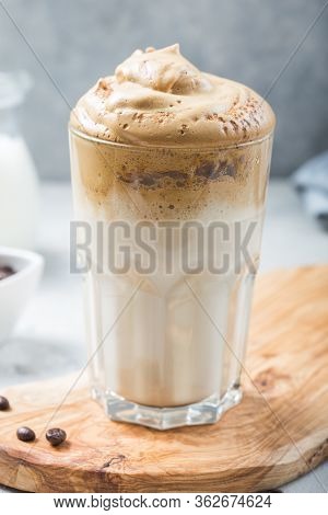 Dalgona Frothy Coffee In Glass On Grey. Trend Korean Drink Latte With Foam Of Instant Coffee. Close 