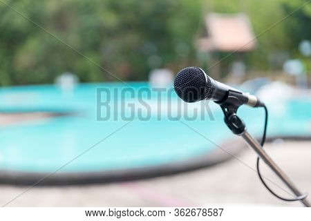 Microphone Outdoor Near Swimming Pools Soft And Blur Style For Background. Microphone Over The Abstr