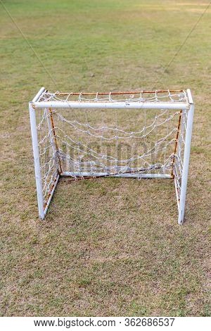Mini Soccer Goal On The Green Grass Field. Outdoors Mini Football Court. Mini Football Goal.