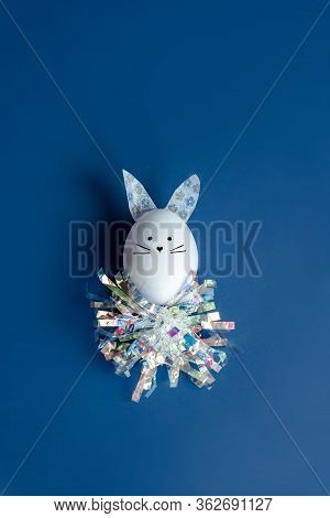 Easter Holiday Concept With Cute Handmade Egg Bunny. Frame With Copy Space For Text. One Easter Egg 