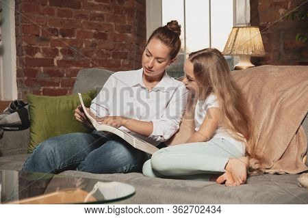 Reading Book. Mother And Daughter During Self-insulation At Home While Quarantined, Family Time Cozy