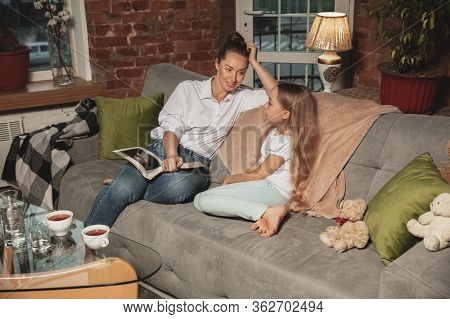 Reading Book. Mother And Daughter During Self-insulation At Home While Quarantined, Family Time Cozy
