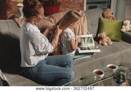 Hairdo, Hairstyle. Mother And Daughter During Self-insulation At Home While Quarantined, Family Time