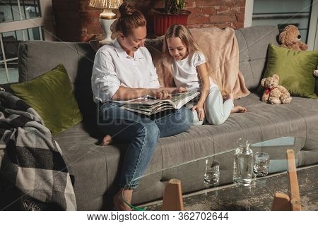 Reading Book. Mother And Daughter During Self-insulation At Home While Quarantined, Family Time Cozy