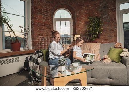 Hairdo, Hairstyle. Mother And Daughter During Self-insulation At Home While Quarantined, Family Time