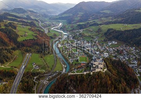Aerial View Of Green Meadows With Villages And Forest In Austrian Alps Mountains.