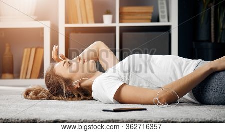 Half-body Pic Of Tired Sportswoman Lying On Floor At Home After Hard Training, Low Angle