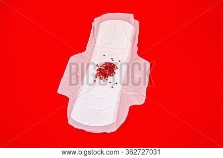 White Feminine Sanitary Pad With Impromptu Monthly Discharge On A Bright Red Background