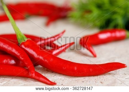 Freshred Hot Peppers On Craft Paper For A Design On A Culinary Or Health Theme.