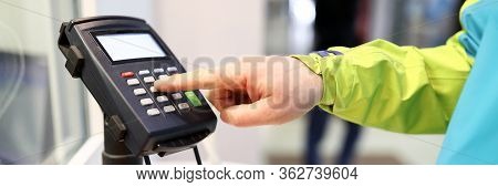 Close-up Of Person Pressing Buttons On Card Machine. Mans Finger Entering Pin Code In Organization. 
