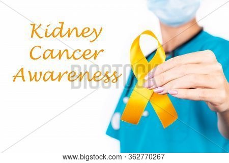 Female Doctor With Orange Ribbon Awareness In Hand As Stop Sign For Kidney Cancer.