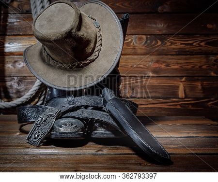 Cowboy Hat, Boots And Rope On Wooden Background