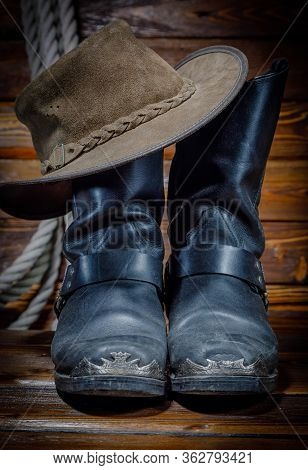 Cowboy Hat, Boots And Rope On Wooden Background