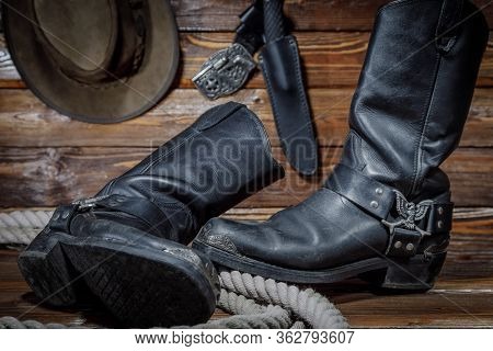Cowboy Hat, Boots And Rope On Wooden Background