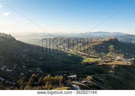 Wide-angle Shot Of Sicilian Landscape With The City Of Calascibetta At Nice Sunset With Shadow Of Th