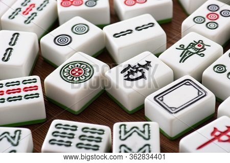 Kyiv, Ukraine - January 30, 2019: White Mahjong Game Tiles With Signs And Characters On Wooden Table