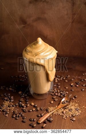 Cold Dalgon Coffee In Clear Glasses On A Dark Wooden Background. Foam From Sugar And Instant Coffee
