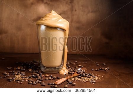 Cold Dalgon Coffee In Clear Glasses On A Dark Wooden Background. Foam From Sugar And Instant Coffee