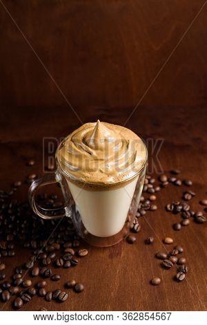 Cold Dalgona Coffee In Clear Glasses On A Dark Wooden Background. Froth Of Sugar And Instant Coffee