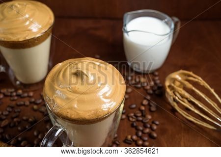 Cold Dalgona Coffee In Clear Glasses On A Dark Wooden Background. Froth Of Sugar And Instant Coffee