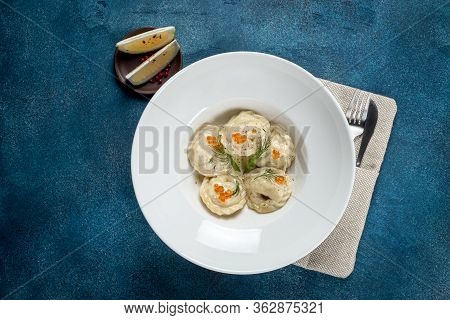Siberian Dumplings Decorated With Caviar And Herbs