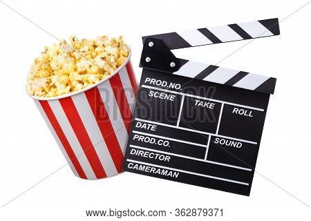 Flying Popcorn And Film Clapper Board Isolated On Black Background