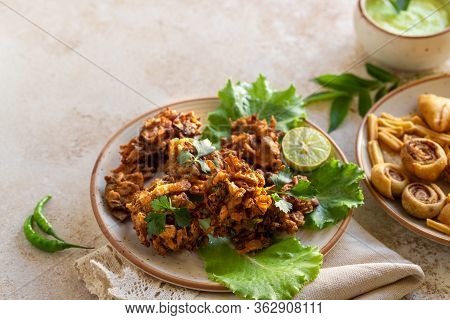 Indian Cuisine Indian Food. Pakora Traditional Indian Deep-fried Snack. Pakoras On Black Plate With 
