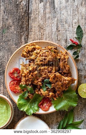 Indian Cuisine. Pakora Traditional Indian Deep-fried Snack. Pakoras On Black Plate With Coconut Chut