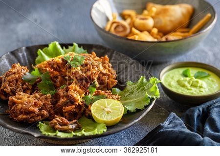 Indian Cuisine Indian Food. Pakora Traditional Indian Deep-fried Snack. Pakoras On Black Plate With 