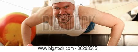 Man At Home Doing Pushups On Carpet And Sofa. Exercises For Problem Areas And Training Other Muscle 