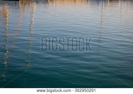 Reflections Of Boats In The Harbor On Sea Water