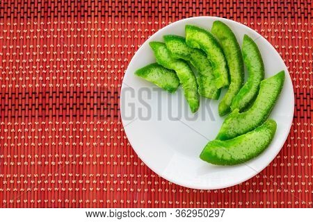 Green Slices Of Exotic Candied Fruit On White Plate. Succade Of Pomelo On Bright Wicker Tablecloth. 