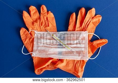 Medical Respirator Bandage And Lab Gloves, Virus Protection Equipment On Blue Background