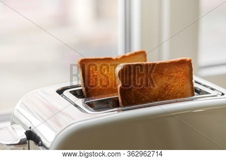 Freshly Baked Toaster Bread. A Couple Of Crusty Toasts In The Toaster, Close-up. Delicious Breakfast
