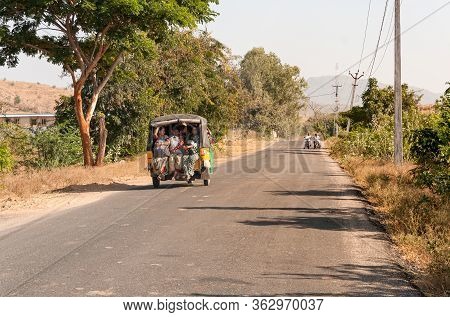 Indian Women Travel In Rickshaw Taxi Along The Road Of Puttaparthi Village, India