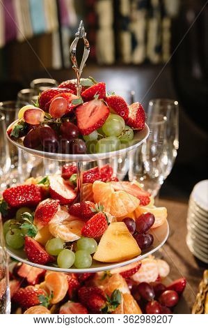 Three-tier Modern Dish With Yellow Brass Plates And A Rod With A Brass Ring Handle For Desserts Or S