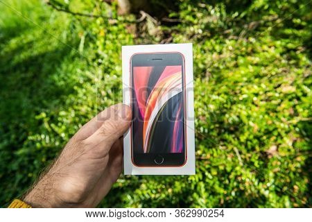 Paris, France - Apr 24, 2020: Man Holding In Garden Close-up Of The New Budget Iphone Se By Apple Co