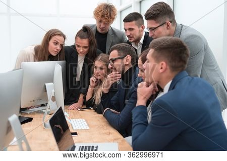 exultant business team looking at the screen of the office computer