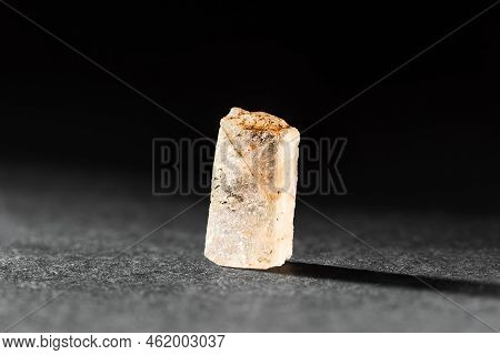 Rough Uncut Yellow Topaz Crystal Sample, Backlit From Behind Over Dark Background. Geological Minera