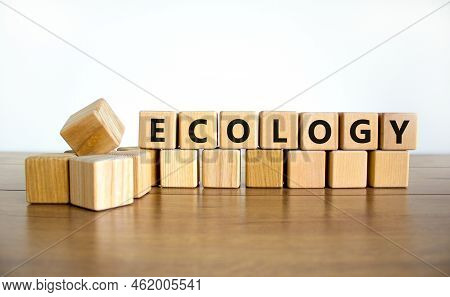 Ecology Symbol. The Concept Word Ecology On Wooden Cubes. Beautiful Wooden Table, White Background, 
