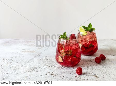 Fresh Summer Lemonade With Raspberry, Lime, Soda Water, And Ice In Glasses. Cold Refreshing Drink, C