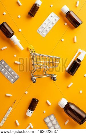 Healthcare Concept. Top View Vertical Photo Of Pushcart Remedy Spray And Syrup Transparent Brown Bot