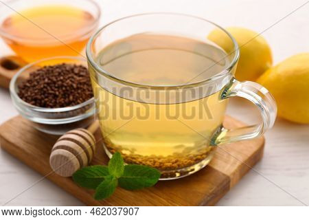 Cup Of Aromatic Buckwheat Tea, Mint And Granules White Wooden On Table, Closeup