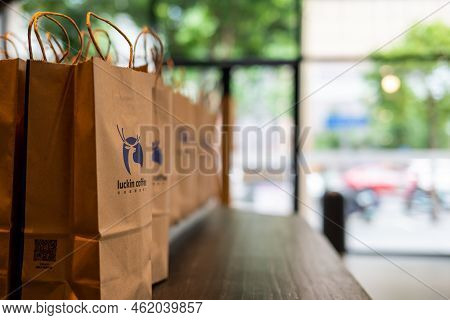 Chengdu, Sichuan Province, China - Sept 21, 2022: Delivery Paper Bags In A Row On A Wooden Table In 