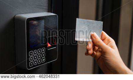 A Woman Opens The Door With A Plastic Card. Modern Keyless Entry Lock.
